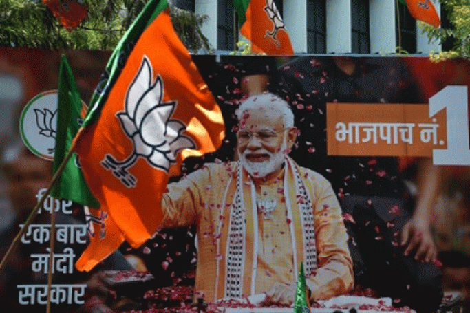  A billboard with an image of Indian Prime Minister Narendra Modi is surrounded by Bharatiya Janata Party (BJP) flags AFP/File 