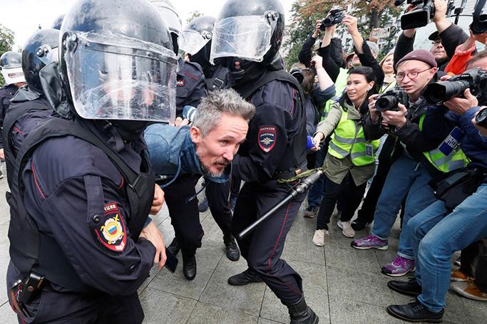 Officers detain a participant during a rally in Moscow. Photo: Reuters