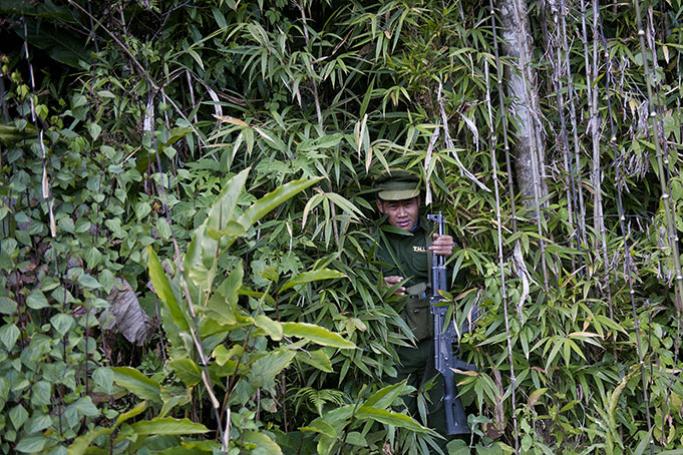 This picture taken on January 16, 2014 shows a soldier of the Taaung National Liberation Army (TNLA), a Palaung ethnic armed group, coming out of a forest in Mantong township, in Myanmar's northern Shan state. PHOTO/Ye Aung THUYe Aung Thu / AFP