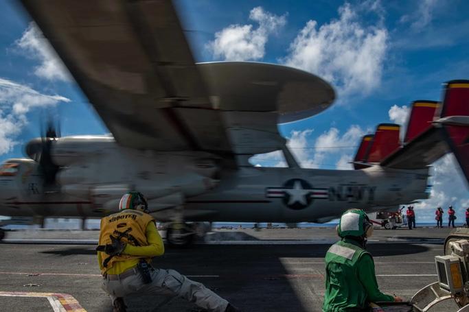An E-2D Hawkeye attached to the Tiger Tails of Airborne Early Warning Squadron 125 launches from the flight deck of the Navy’s only forward-deployed aircraft carrier USS Ronald Reagan in the Philippine Sea. (Photo courtesy of the U.S. Navy)