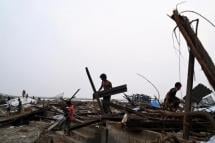 Local residents clean debris of their destroyed houses at the Khaung Dote Khar Rohingya refugee camp in Sittwe, in Myanmar's Rakhine state, on May 15, 2023, after cyclone Mocha made a landfall. Photo: AFP