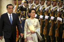 China's Premier Li Keqiang, left, and Myanmar's State Counselor Aung San Suu Kyi, right, review an honor guard during a welcome ceremony at the Great Hall of the People in Beijing. Pic: AP