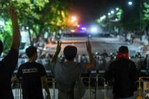 Protesters gesture toward riot police in Bangkok on Oct 15, 2020. (Photo: AFP/Panumas Sanguanwong)